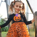 Little girl in pumpkin Halloween themed costume