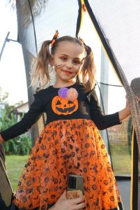 Little girl in pumpkin Halloween themed costume