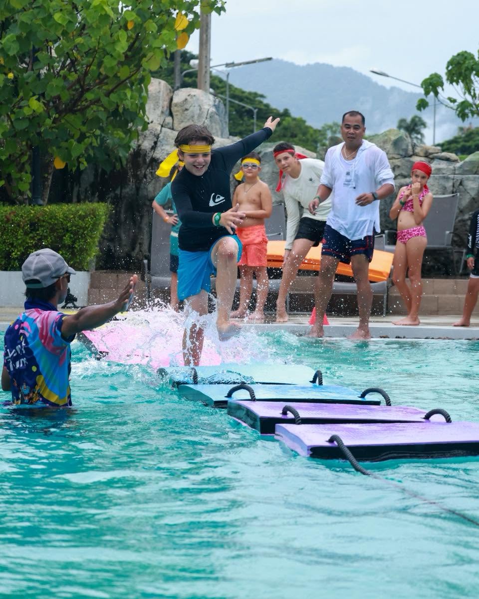 Boy having fun running towards the pool