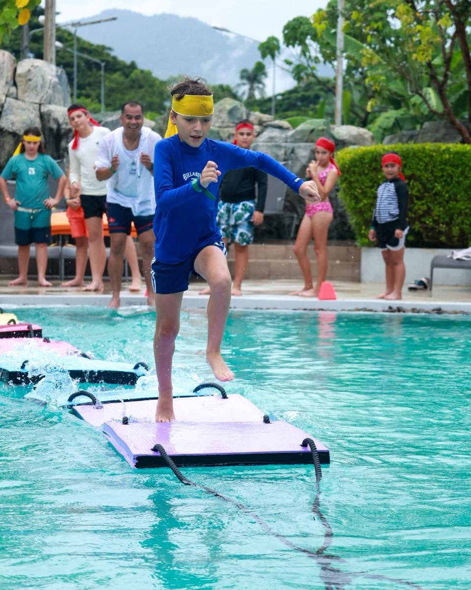 Boy running for a dive in the pool