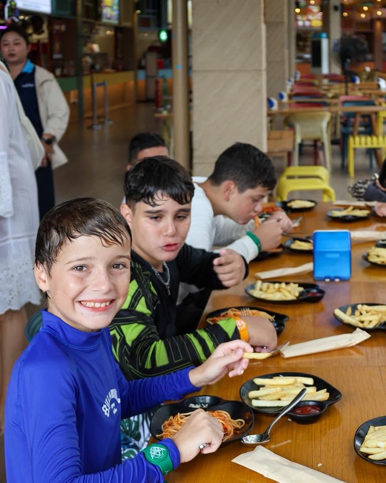 Lighthouse International School Students eating at the cafe after playing in the pool