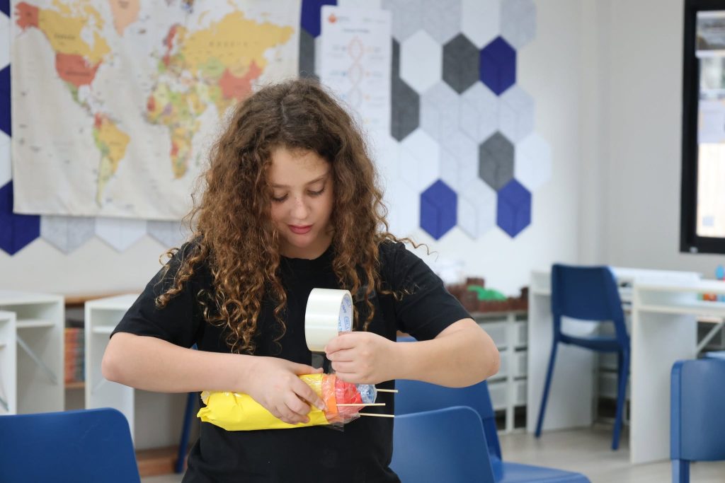 Lighthouse student creating rocket from plastic bottles