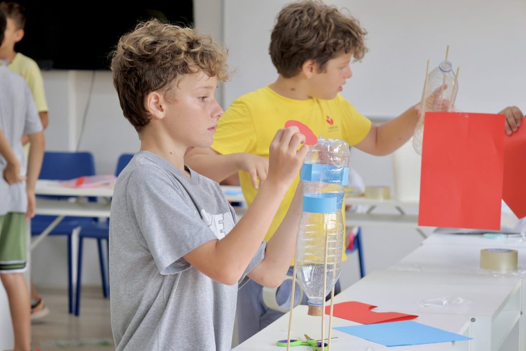 Students creating rocket from plastic bottles
